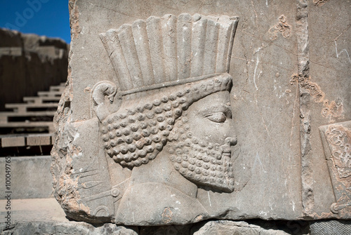 Head of ancient warrior on the destroyed stone bas-relief in famous city Persepolis