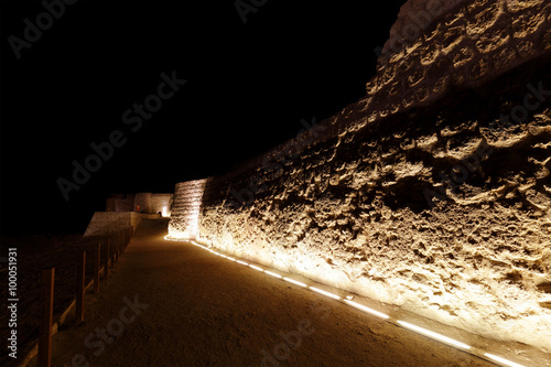 Western walls of Bahrain fort at night