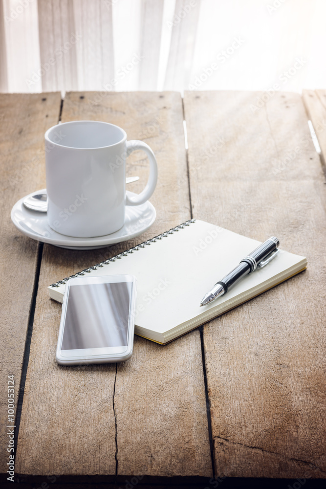 cup of coffee, notebook, pen and smart phone