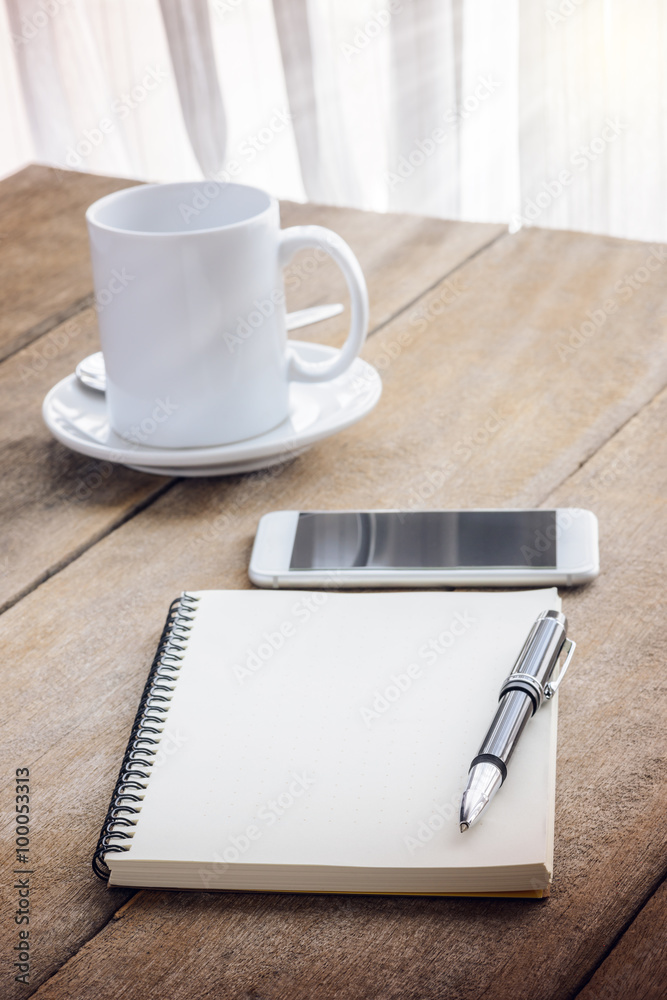 cup of coffee, notebook, pen and smart phone cup of coffee, notebook, pen and smart phone