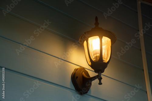 Warm light of external lamps on the house wall