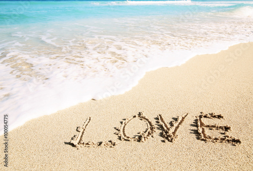 Love inscribed in the sand of a beach