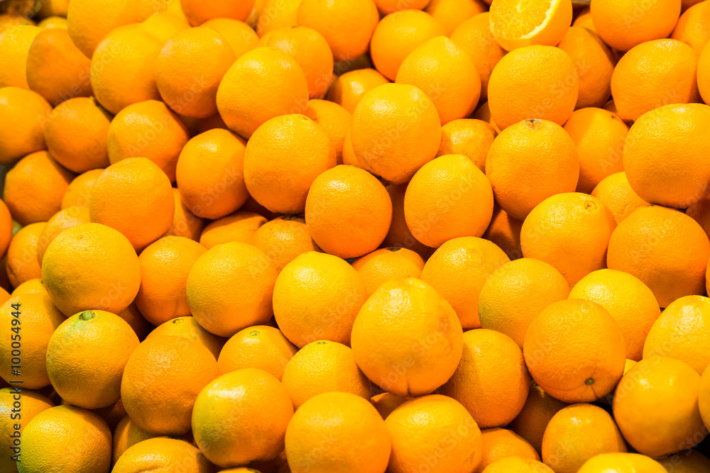Bunch of fresh oranges for retail sale at an outdoor market.