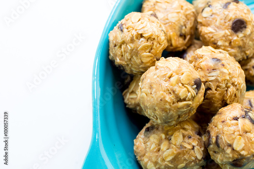 energy balls in a blue bowl on a white background