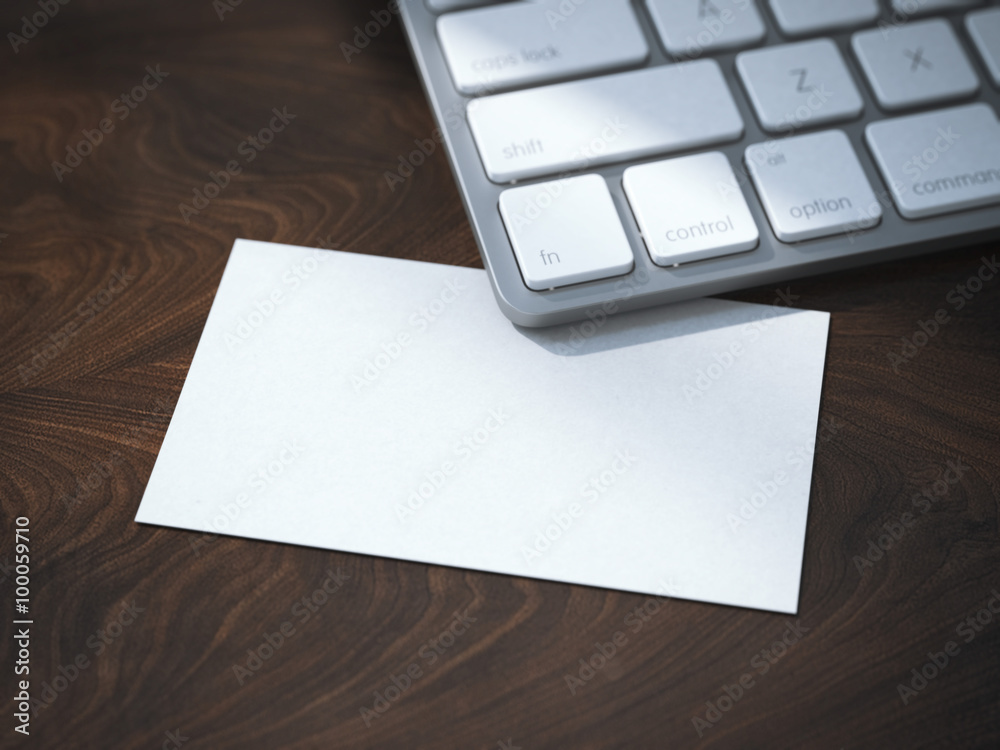 Blank white business card under keyboard Blank white business card under keyboard