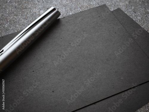 Black business card with luxury silver pen