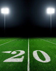 Football field illuminated by stadium lights