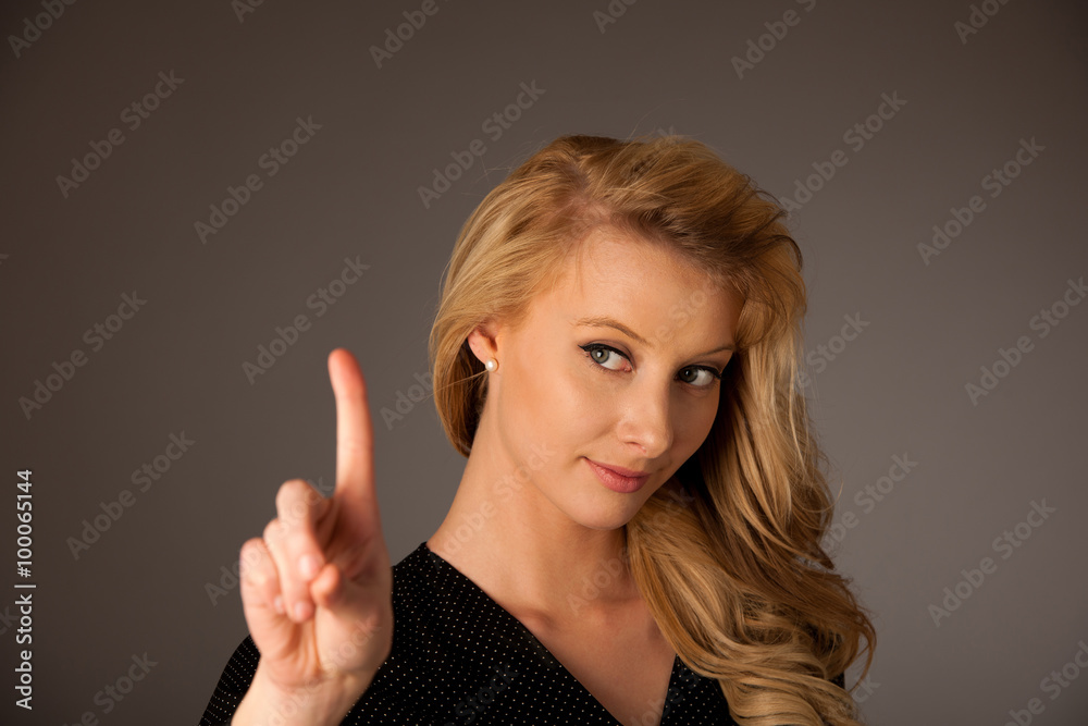 woman pointing into copy space pressing a virtual button over gr