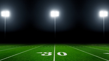 Football field illuminated by stadium lights