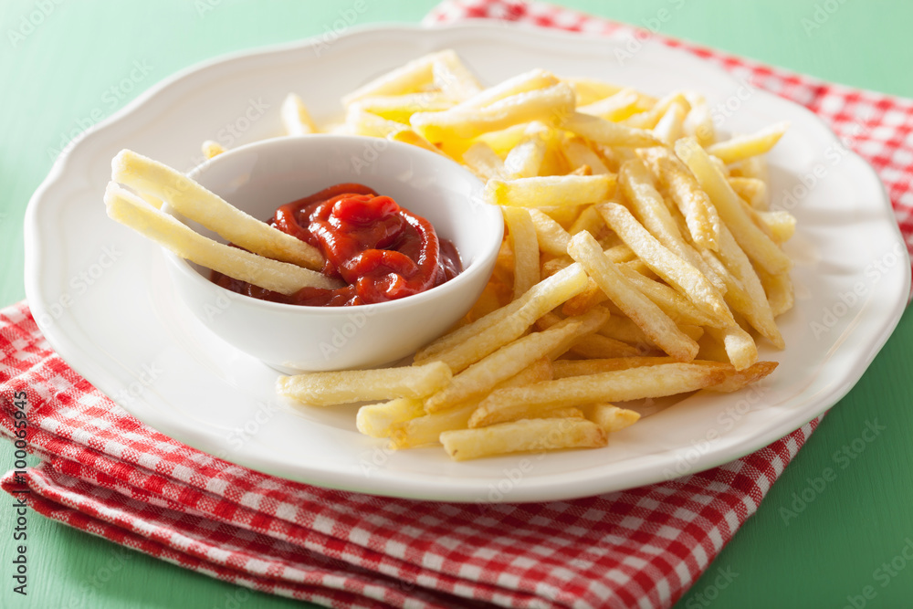french fries with ketchup over green background french fries with ketchup over green background