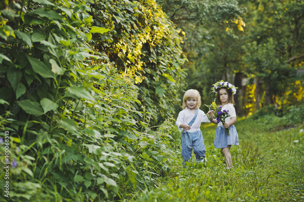 A boy and a girl walking in the green garden 4762. A boy and a girl walking in the green garden 4762.