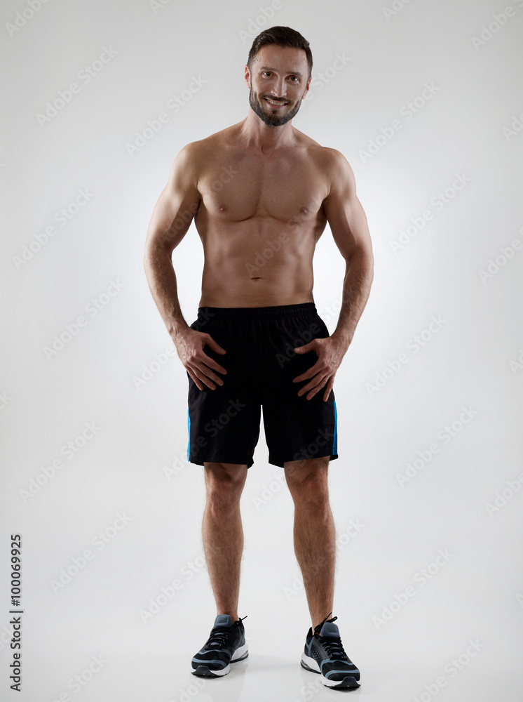 Cheerful shirtless sportsman