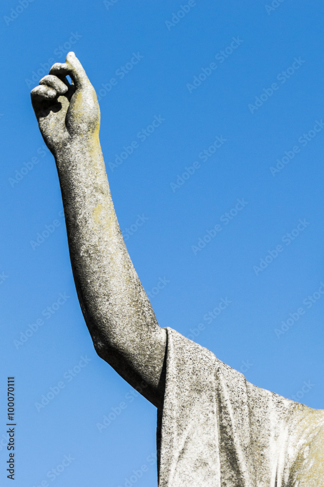 More than 100 years statue with arm upward