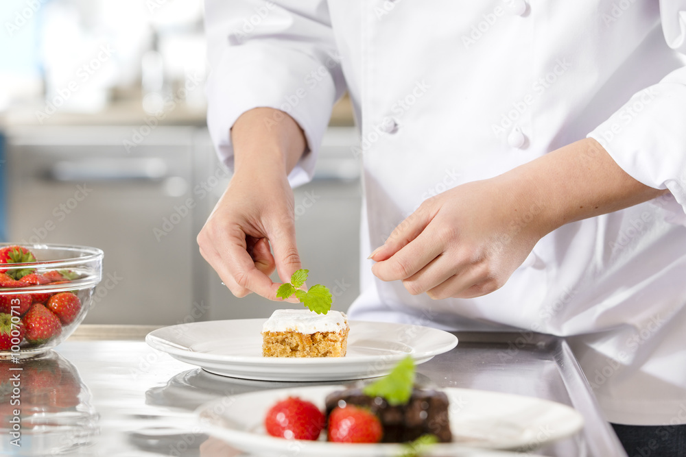 Chef decorate dessert cake with lemon leaf