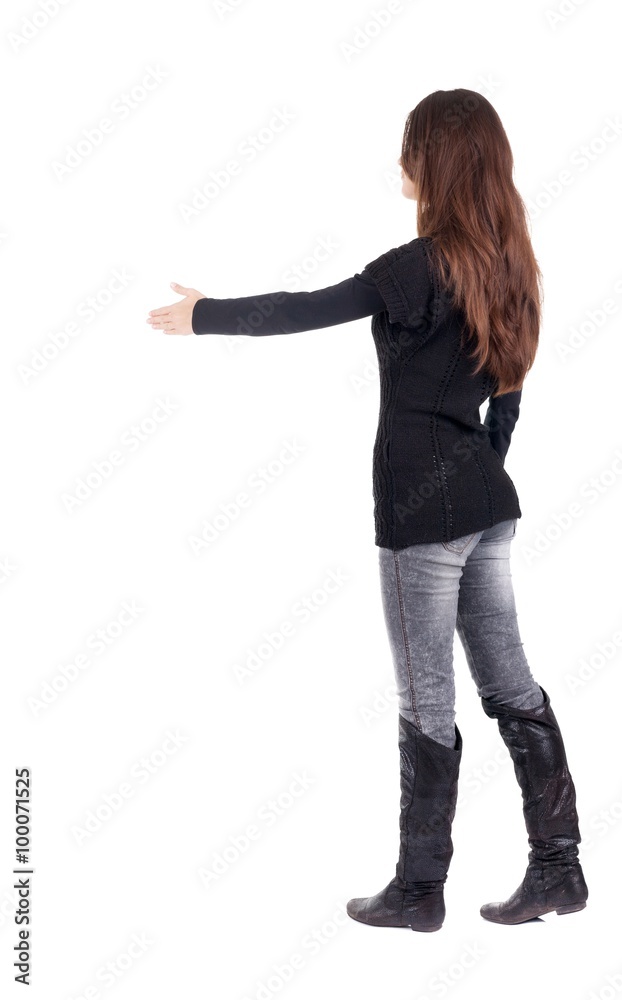 back view of businesswoman  reaches out to shake hands.