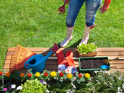 Woman with gardening tools, flowers and pots 
