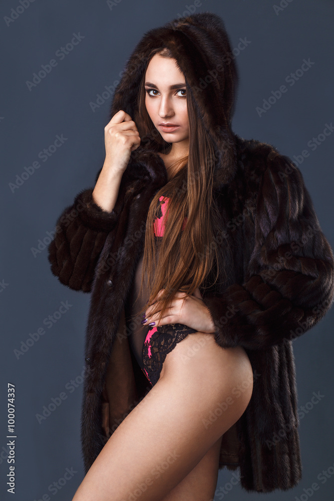 Sexy young girl in a fur coat and underwear. Gray background. Studio.
Sexy young girl in a fur coat and underwear. Gray background. Studio.
