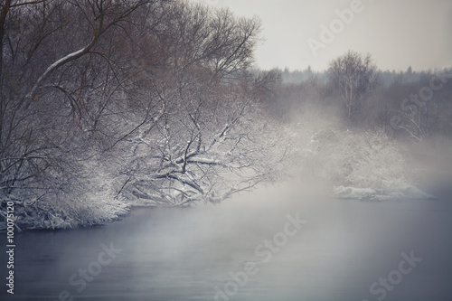 Misty winter river. Winter fog ober the river.