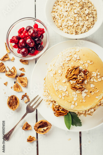 delicious pancakes on a wooden table with nuts