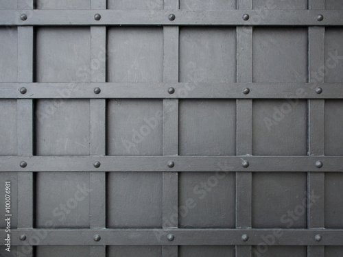 pattern of squares grid on a gray iron door