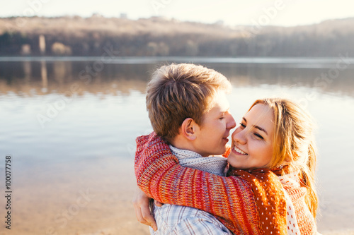 Young couple in love outdoor at a lake