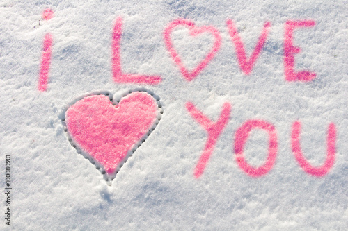 I love you with heart sign writing on the snow. 