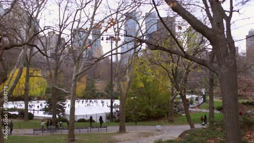 Slow panning shot of iceskating rink in central park.
