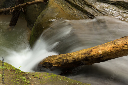 Beautiful smooth flowing stream with a small waterfall