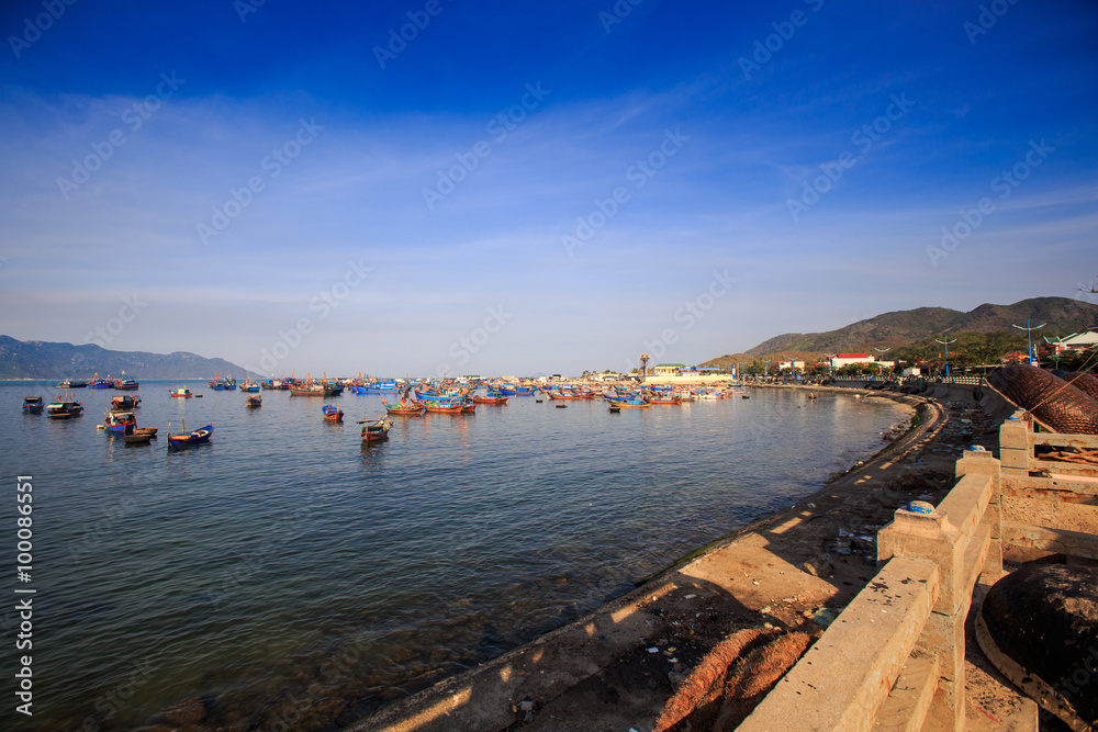 distant group of Vietnamese fishing boats in azure sea