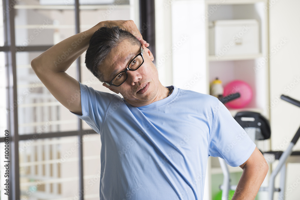 asian senior male streching at the gym asian senior male streching at the gym