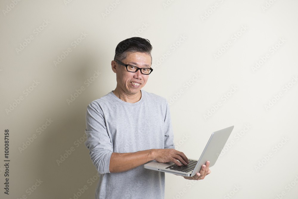 asian casual senior with laptop asian casual senior with laptop