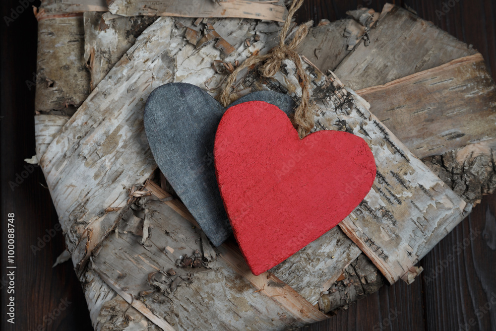 Obraz premium Wooden hearts on dark wood background