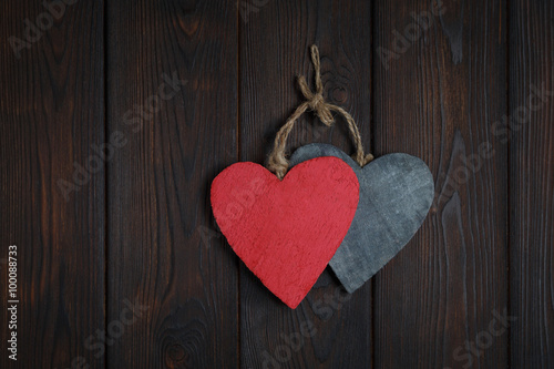 Wooden hearts on dark wood background