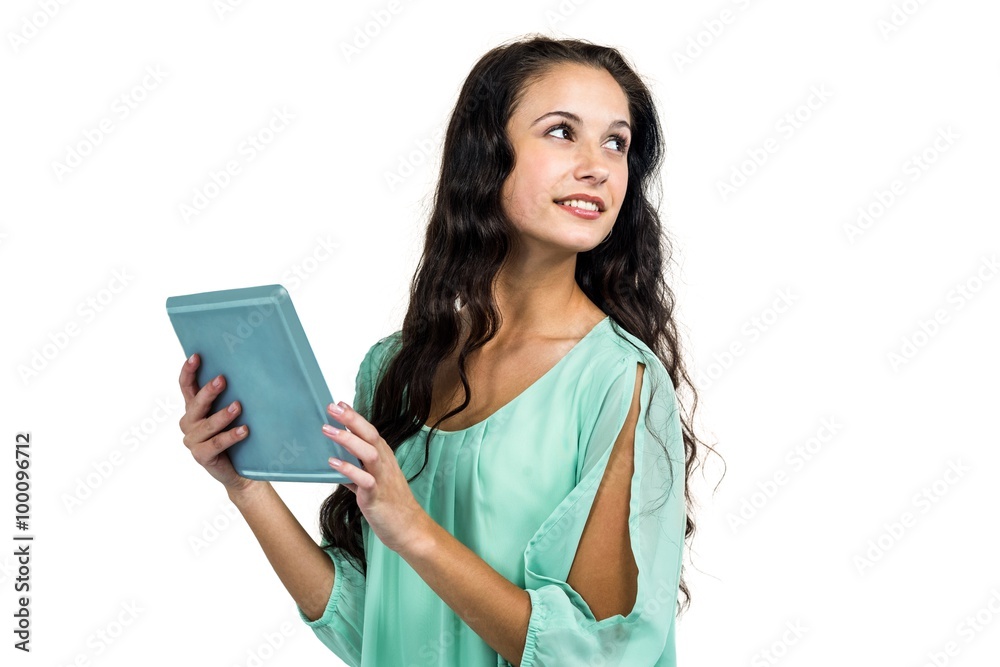 Smiling woman holding tablet and looking away Smiling woman holding tablet and looking away