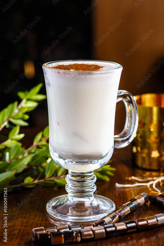 Tea with milk and cinnamon in a glass Cup Tea with milk and cinnamon in a glass Cup