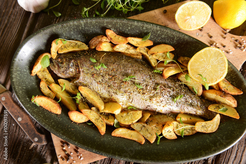 Roasted trout with potatoes in thyme
