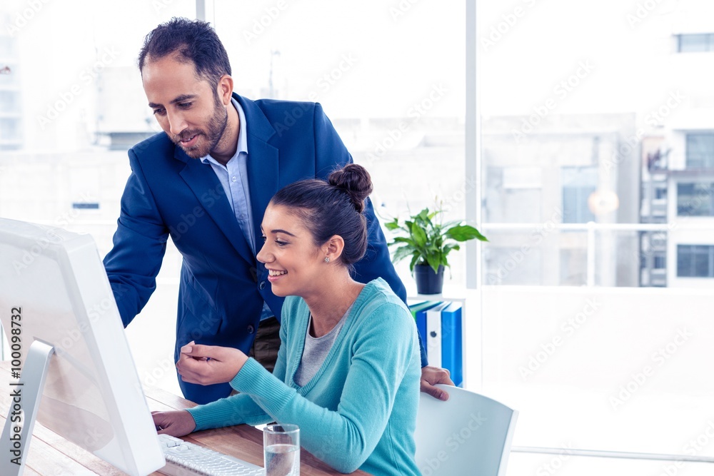 Fototapeta premium Happy businessman and businesswoman working on computer