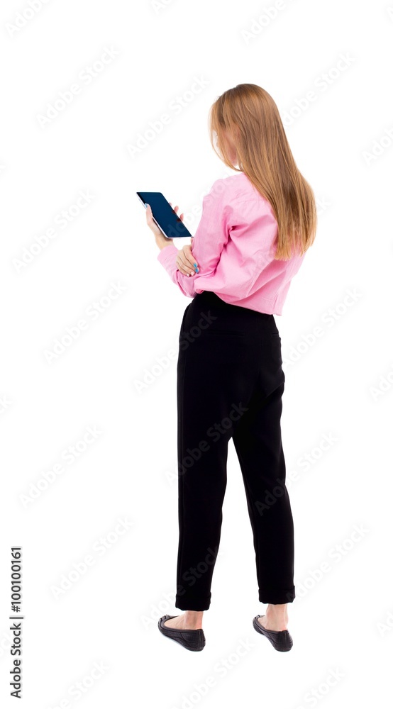 back view of standing young beautiful girl with tablet computer back view of standing young beautiful girl with tablet computer