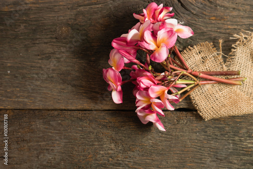 The beautiful pink Plumeria flower on the old wood background st