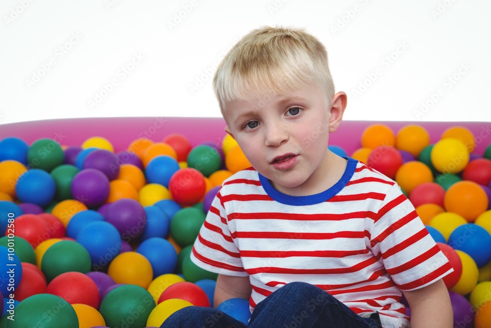 Obraz premium Cute smiling boy in sponge ball pool