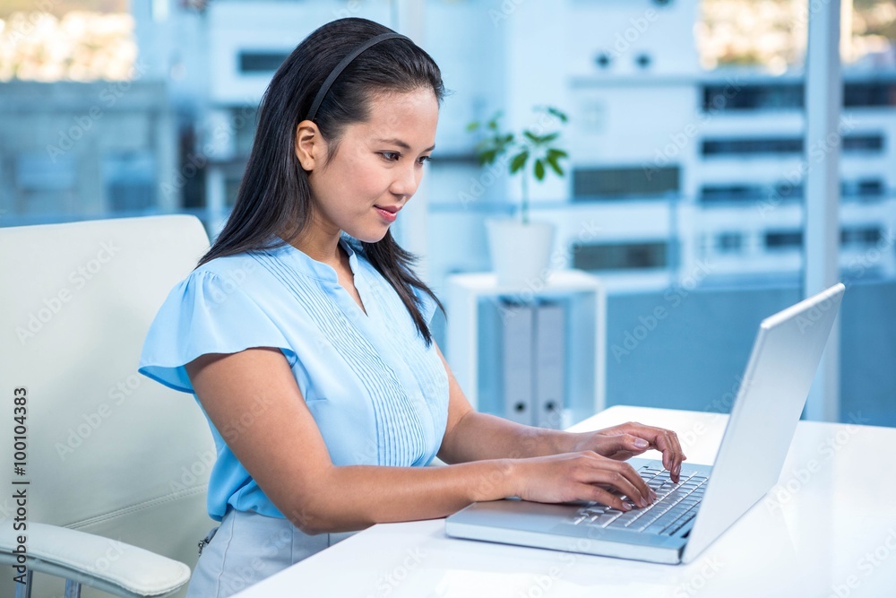 Smiling businesswoman using laptop Smiling businesswoman using laptop