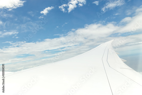 Airplane Wing in Flight from window, cloud sky