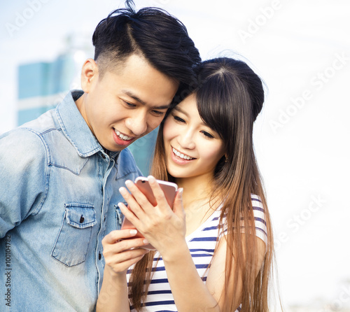 Happy young couple with smart phone