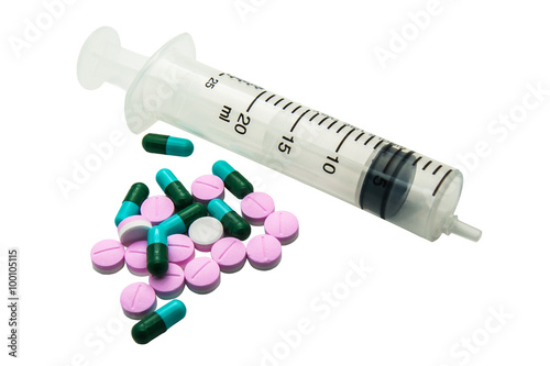 plastic syringes with medical pill and tablets on whith backgrou
