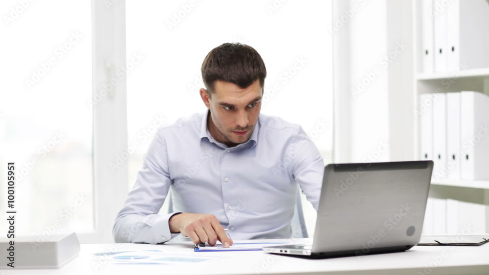 busy businessman with laptop and papers in office busy businessman with laptop and papers in office