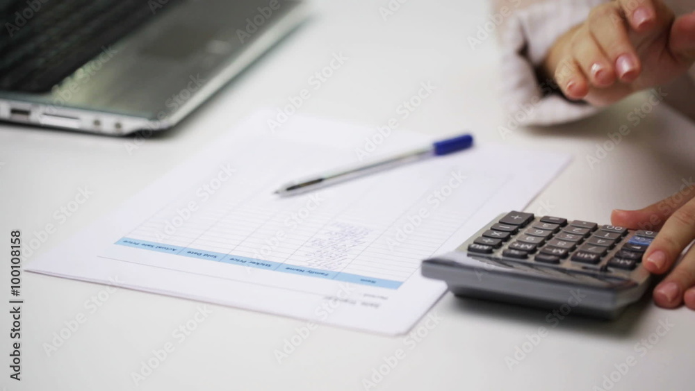 businesswoman with laptop, calculator and papers businesswoman with laptop, calculator and papers