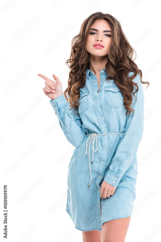 Beautiful young woman with long curly hair pointing away Beautiful young woman with long curly hair pointing away