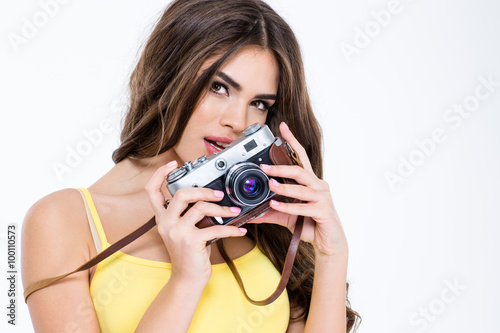 Charming woman holding retro camera