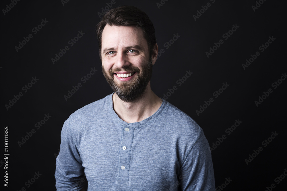 Portrait of a men with beard and mustache in studio black background