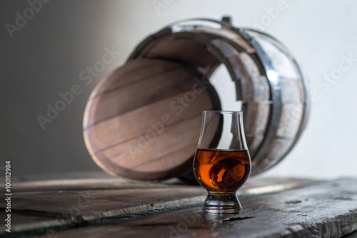 A glass of spirits in the oak barrel